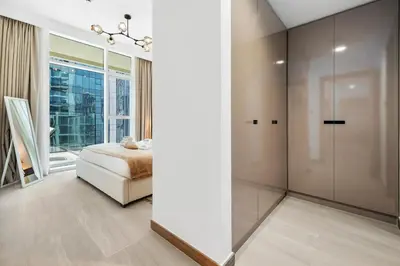 a bedroom with a bed and a large window at BLVD - Missoni Canal View - Walk to Dubai Mall in Dubai