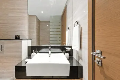 a bathroom with a white sink and a mirror at BLVD - Missoni Canal View - Walk to Dubai Mall in Dubai