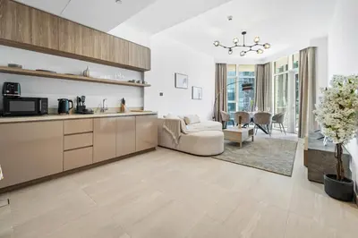 a kitchen and living room with a couch and a table at BLVD - Missoni Canal View - Walk to Dubai Mall in Dubai