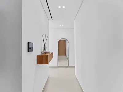 a hallway with white walls and a white floor at Upscale 2Bedroom with Private Balcony Pool in JVC in Dubai