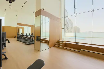 a waiting room with chairs and a large window at Upscale 2Bedroom with Private Balcony Pool in JVC in Dubai