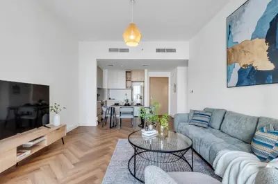 a living room with a couch and a table at Relax & Unwind with Dubai Creek Vibes in Dubai