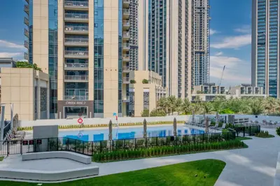 a resort with a swimming pool in front of tall buildings at Relax & Unwind with Dubai Creek Vibes in Dubai