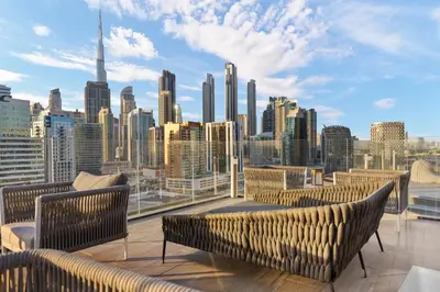 a balcony with chairs and a view of the city at Waves - Stylish Studio Near Downtown Dubai in Dubai
