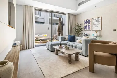 a living room with a couch and a table at New 2.5 BR Villa With PS5 and Garden Near Dubai Mall in Dubai