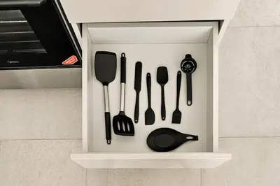 a drawer filled with utensils in a kitchen at New 2.5 BR Villa With PS5 and Garden Near Dubai Mall in Dubai