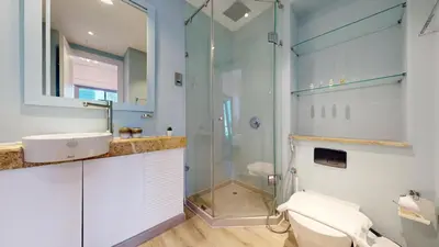 a bathroom with a glass shower and a toilet at Iris Blue - Colourful One Bedroom in The Marina in Dubai