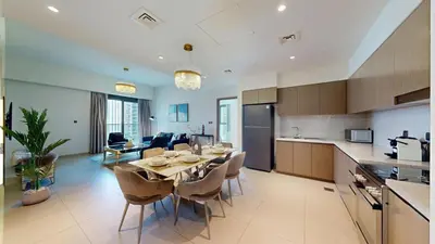 a kitchen and dining room with a table and chairs at Vacationer l Vibrant 2 Bedroom l Pool with Burj Khalifa View in Dubai