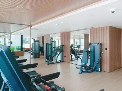 a gym with treadmills and elliptical machines at Binghatti Tulip - High Rise Upgraded Studio in JVC in Dubai