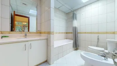 a bathroom with a sink and a tub and a toilet at Sherlock House 2 - Peaceful One Bed in Motor City in Dubai