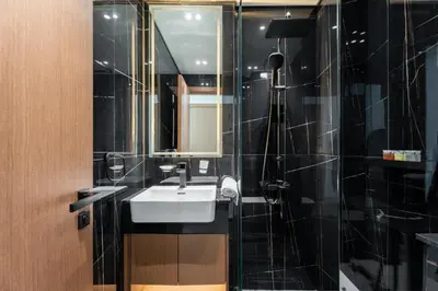 a bathroom with a sink and a mirror and a shower at GuestReady - Top-Floor Tranquillity in JVC in Dubai