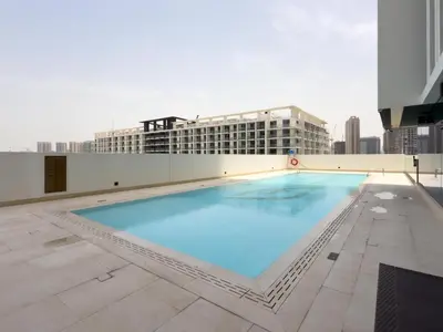 a large swimming pool on the roof of a building at GuestReady - Top-Floor Tranquillity in JVC in Dubai