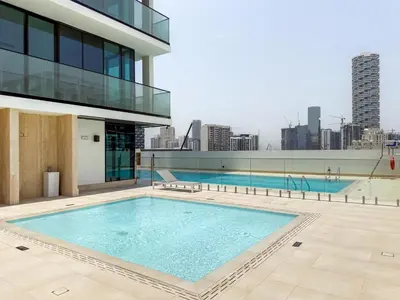 a large swimming pool on the roof of a building at GuestReady - Top-Floor Tranquillity in JVC in Dubai