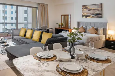 a living room with a couch and a table at Rimal 3, JBR - Studio Apartment - Allsopp & Allsopp in Dubai