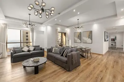 a living room with a couch and a table at 4 Bedroom Sea View Apartment in Jumeirah Beach Residence in Dubai