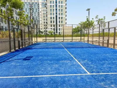 a tennis court in the middle of a city at Modern 1BR with Cinema, Pool and Gym Dubai Hills in Dubai