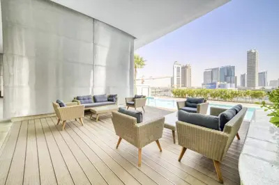 a living room with chairs and a pool on a building at Luxe 1BR in RP Heights Downtown - 50mt to Dubai Mall, walk to Burj Khalifa and Fountain in Dubai