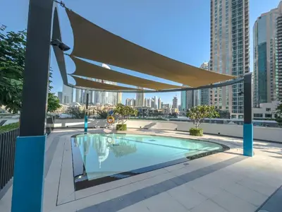 awning over a swimming pool on top of a building at Bitcoin Moonrise 2BR - Grande Burj Views in Dubai