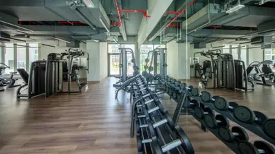 a gym with rows of exercise bikes and a person in the middle at Silk Valley - Modern 2BR Near Park & Attractions in Dubai