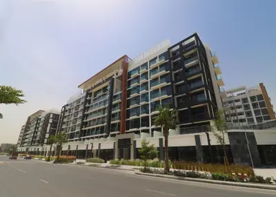 a large building on the side of a street at Peaceful 1BR with Community View, Quick Downtown and Golf Club Access, Azizi Riviera 34, Al Merkadh by Deluxe Holiday Homes in Dubai