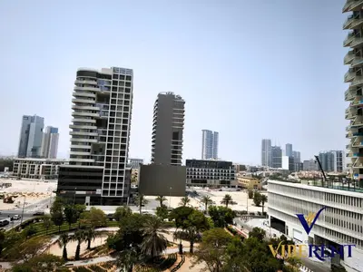 a city skyline with tall buildings and palm trees at Damac 1BHK, Terrance Pool, 20 Min to Downtown in Dubai