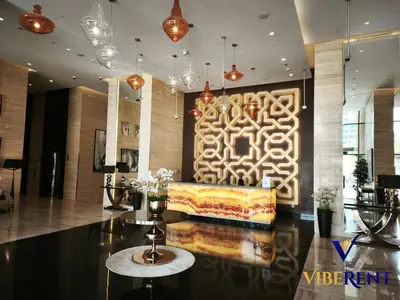 a lobby with a couch in the middle of a room at Damac 1BHK, Terrance Pool, 20 Min to Downtown in Dubai