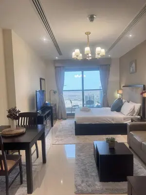a bedroom with a bed and a living room with a view at Dubai Downtown Canal View Studio 2306 in Dubai