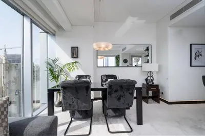 a dining room with a table and chairs at Waterfront Luxury 2 Bed in Marina Mall Hotel in Dubai