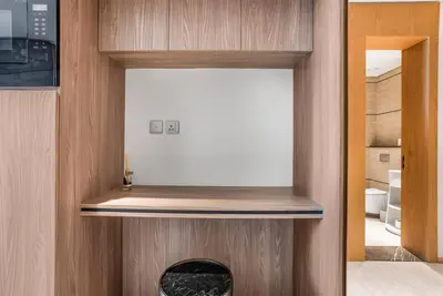 a room with a wooden wall with a fireplace at Brand New Luxury Studio in JVC in Dubai