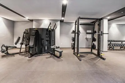 a gym with several equipment in a room at Brand New Luxury Studio in JVC in Dubai