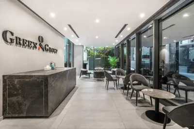 a restaurant with tables and chairs in a building at Brand New Luxury Studio in JVC in Dubai