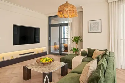 a living room with a couch and a table at Seraya at Dubai Creek South Residence in Dubai