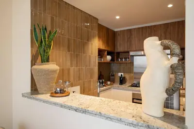 a kitchen with a counter with a vase on it at Seraya at Dubai Creek South Residence in Dubai
