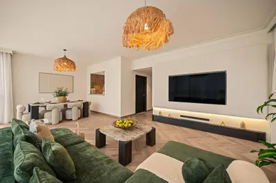 a living room with a couch and a flat screen tv at Seraya at Dubai Creek South Residence in Dubai