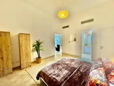 a living room with a couch and a table at Regent House 1 Motor City in Dubai