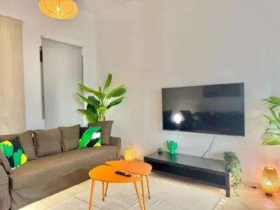 a living room with a couch and a tv at Regent House 1 Motor City in Dubai