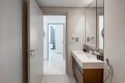 a white bathroom with a sink and a mirror at Beach Isle 1 Emaar Beachfront - Mint Stay in Dubai