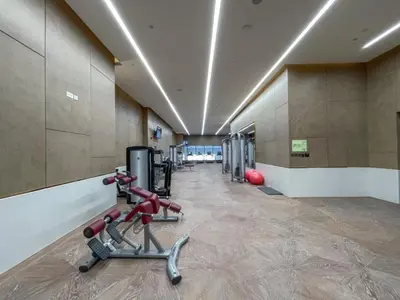 a gym with a treadmill and exercise equipment in a room at Steps from Nakheel Mall and Monorail Station, Near Beach Clubs ,15 Mins to Downtown and Marina, The Palm Tower, Palm Jumeirah by Deluxe Holiday Homes in Dubai
