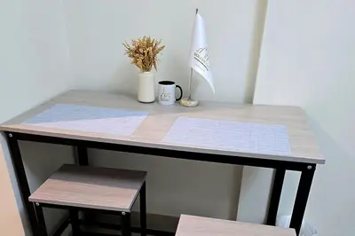 a table with a cup and a potted plant on it at Azizi Riviera 43 - Meydan by Golden Casa in Dubai