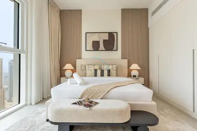 a bedroom with a large bed and a large window at Steps from Marina Beach, AquaFun & The Walk, Mins to Bluewaters Island and Ain Dubai - La Vie, Jumeirah Beach Residence by Deluxe Holiday Homes in Dubai