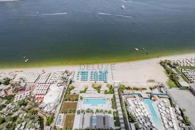 an aerial view of the beach and hotels at Steps from Marina Beach, AquaFun & The Walk, Mins to Bluewaters Island and Ain Dubai - La Vie, Jumeirah Beach Residence by Deluxe Holiday Homes in Dubai