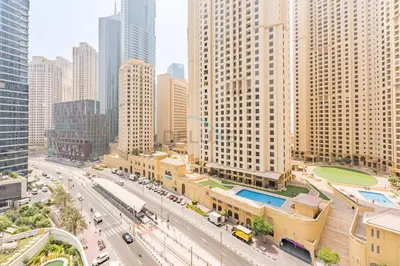 an aerial view of a city with tall buildings at Seamless Access to Marina Mall, JBR Beach, Dining And Shopping Spots, Just A Few Meters from the Tram Station - Continental Tower, Dubai Marina by Deluxe Holiday Homes in Dubai
