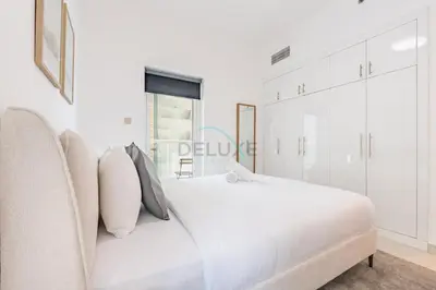 a white bedroom with a white bed and a window at Seamless Access to Marina Mall, JBR Beach, Dining And Shopping Spots, Just A Few Meters from the Tram Station - Continental Tower, Dubai Marina by Deluxe Holiday Homes in Dubai
