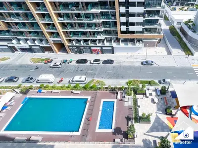 an overhead view of a swimming pool in front of a building at Amazing Studio in Meydan l Pool , Gym & Balcony in Dubai