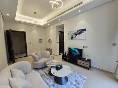 a living room with two couches and a tv at Stylish 1-Bedroom Apartment in Dubai