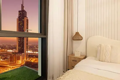 a bedroom with a window with a view of a city at Mahogany 17 - 2BR 10PAX - On the Boulevard Sea View in Dubai