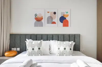 a bedroom with a large bed with white pillows at Trendy 2BR Apartment near Burj Khalifa, Downtown Dubai in Dubai