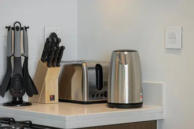 a kitchen counter with a coffee pot and a toaster at Trendy 2BR Apartment near Burj Khalifa, Downtown Dubai in Dubai