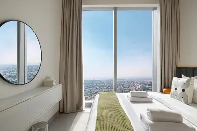 a bedroom with a large window with a mirror at Trendy 2BR Apartment near Burj Khalifa, Downtown Dubai in Dubai