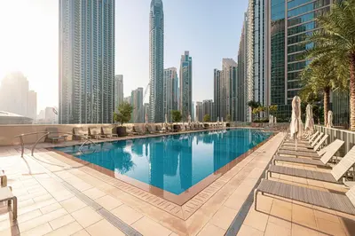 a pool in the middle of a city with tall buildings at Trendy 2BR Apartment near Burj Khalifa, Downtown Dubai in Dubai